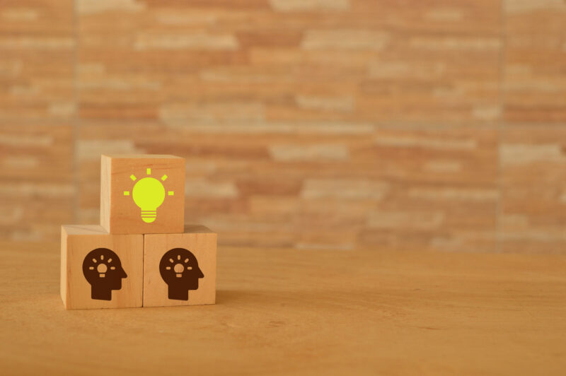 Human head and light bulb symbol on wooden blocks. Problem solving, creative idea and innovation concept.