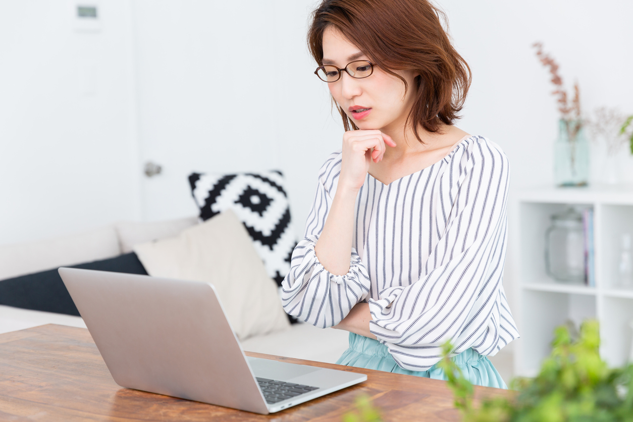 Beautiful young asian woman using laptop,think,
