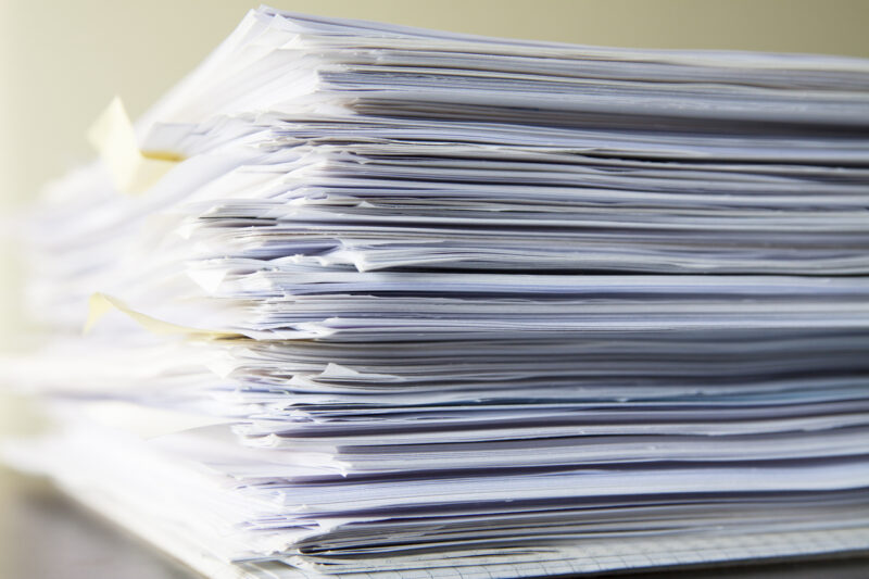 Stack of files, documents waiting to be processed.
